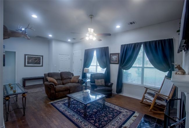 Living area with a ceiling fan, wood finished floors, and recessed lighting | Image 7