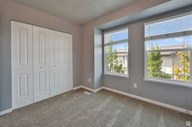 Unfurnished bedroom with carpet flooring and a closet | Image 24