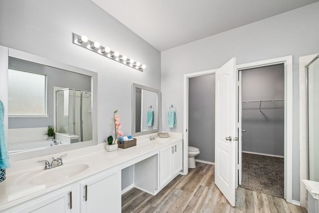Bathroom with a stall shower, a bathtub, toilet, a sink, and wood finished floors | Image 24