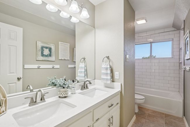 Bathroom with double sink vanity and shower / tub combination | Image 24