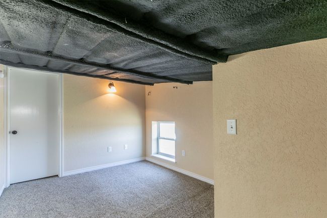Unfurnished room featuring a textured wall, carpet flooring, and baseboards | Image 28