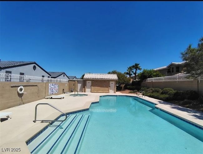 Community pool featuring a fenced backyard, a patio area, and a hot tub | Image 27