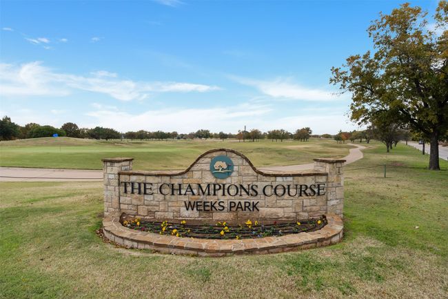 Community sign with a yard and view of golf course | Image 39