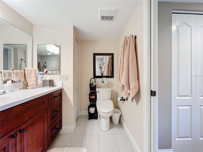 Primary bath includes pocket door between closets and bath | Image 33