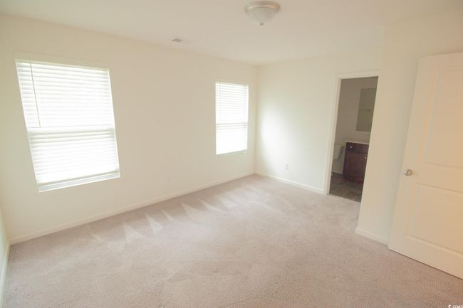 Unfurnished room with light carpet and baseboards | Image 9