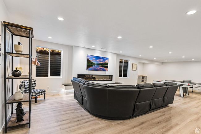 Living room with light wood-style floors, baseboards, and recessed lighting | Image 35