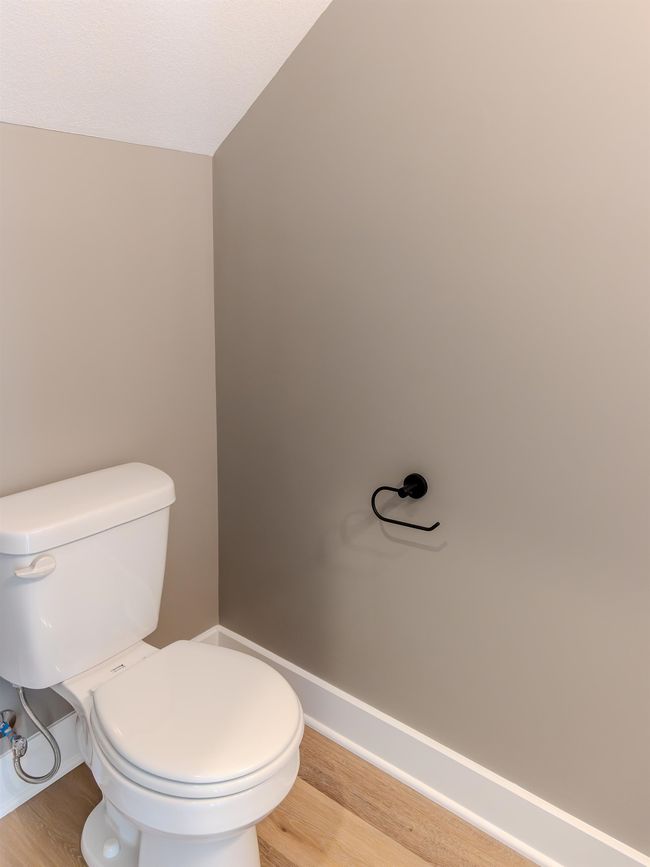Bathroom with lofted ceiling, toilet, and hardwood / wood-style floors | Image 6