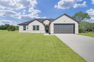 View of front of property with a garage and a front yard | Image 1