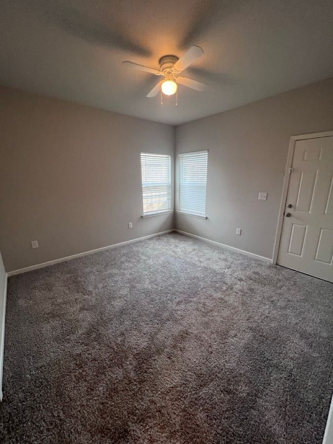 Empty room featuring ceiling fan, baseboards, and carpet flooring | Image 5