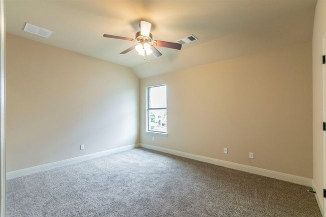 Bedroom 4 featuring vaulted ceiling, visible vents, a ceiling fan, and baseboards | Image 35
