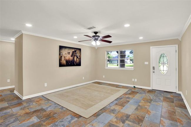 Living room and front door from dining area | Image 10