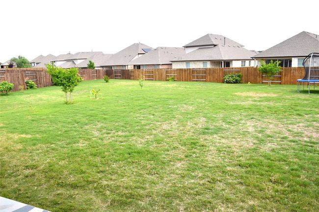View of yard with a trampoline and a residential view | Image 30