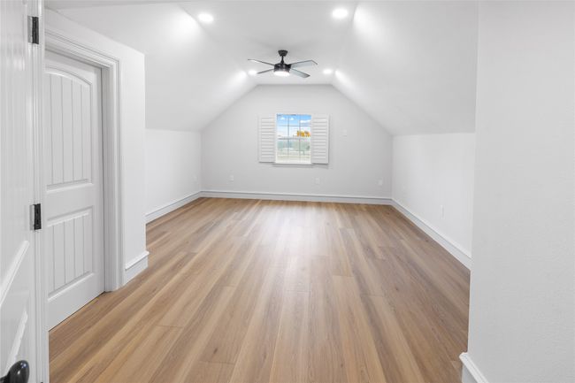 Bonus room with a ceiling fan, light wood-style flooring, vaulted ceiling, and recessed lighting | Image 33