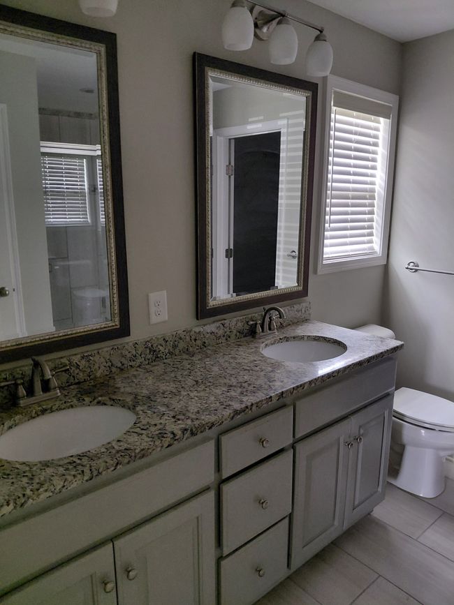 Primary bedroom with double vanities and granite counter tops. | Image 7