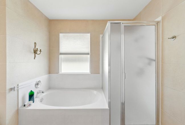 Bathroom featuring a shower stall and a garden tub | Image 21