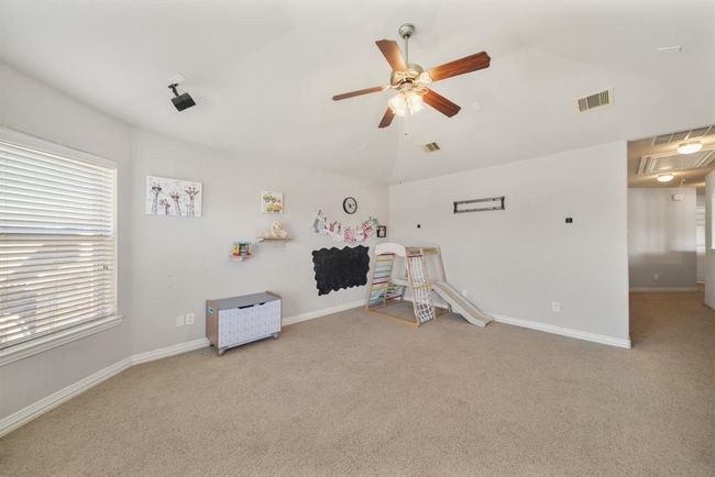 Features include a high ceiling with ceiling fan & light fixture, two ceiling mounted speakers, pre-wiring for surround speakers & carpet. | Image 28
