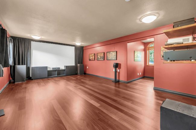 Home theater with baseboards and wood finished floors | Image 27