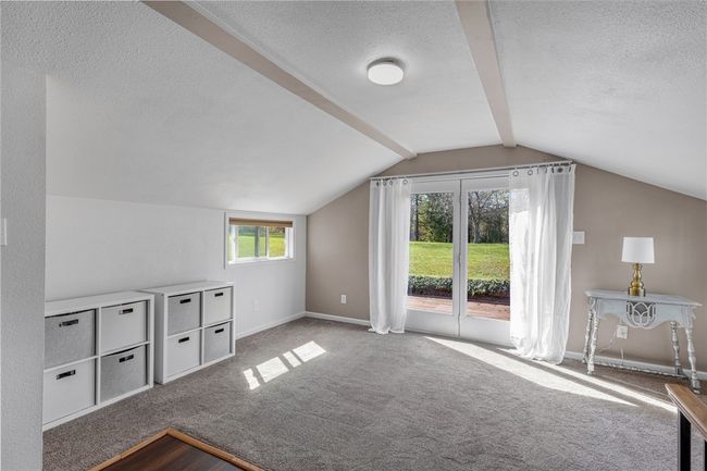 Upper level guest bedroom that is currently being used as an office. Door lead to back deck. | Image 22