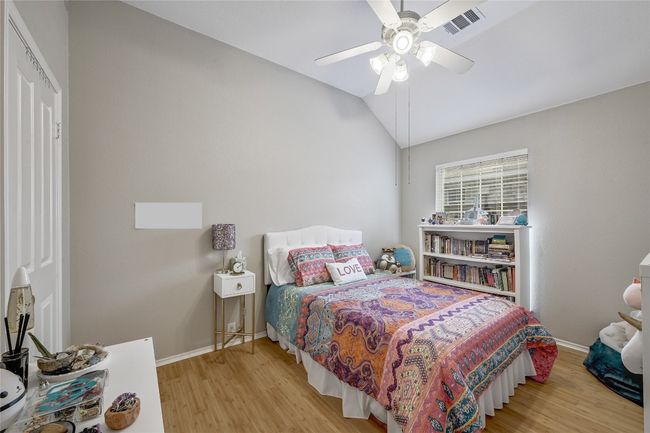 2nd Bedroom with wood finished floors, vaulted ceiling, baseboards, and a ceiling fan | Image 16
