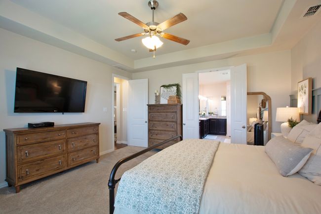 Bedroom featuring visible vents, baseboards, connected bathroom, carpet, and a tray ceiling | Image 18