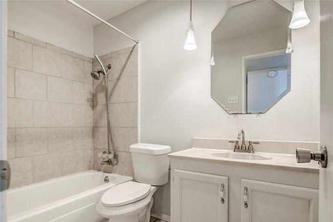 Bathroom featuring toilet, vanity, and shower / bathtub combination | Image 30