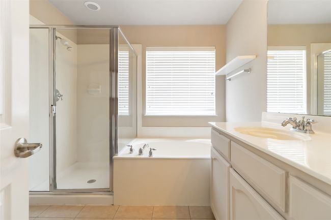 Full bath with tile patterned floors, a shower stall, vanity, and a healthy amount of sunlight | Image 11