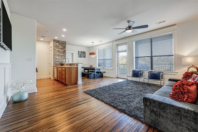 Living area featuring visible vents, baseboards, wood finished floors, recessed lighting, and a ceiling fan | Image 4
