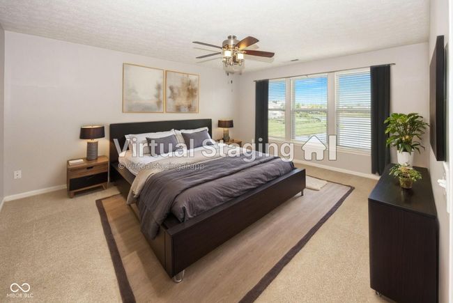 Spacious primary bedroom with tranquil pond view was virtually staged to allow you to visualize a potential furniture arrangement. | Image 30
