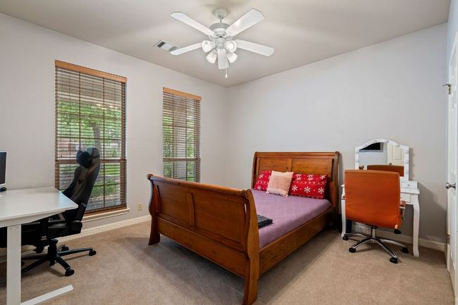 Carpeted bedroom featuring baseboards, a ceiling fan, and visible vents | Image 28