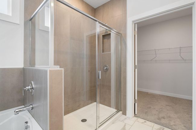 The master bathroom is a true retreat, highlighted by a massive full-height tiled shower that adds a touch of luxury and sophistication. Its spacious design creates the perfect place to relax and recharge. | Image 25