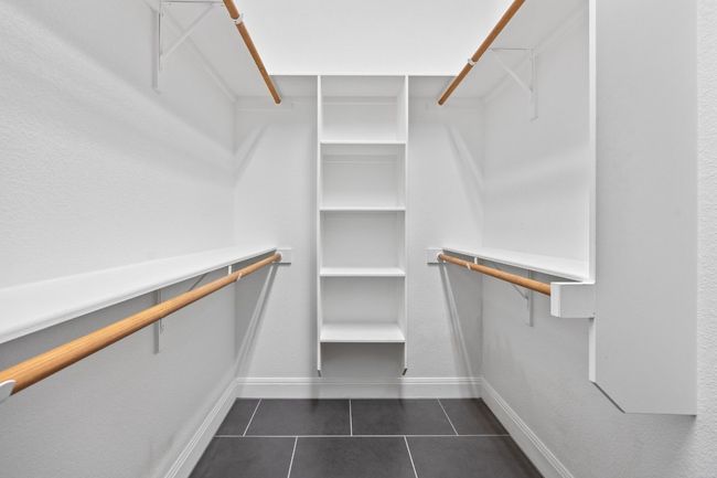 This walk-in closet checks every box; room to organize, space to spare, and easy access right off the ensuite bath | Image 22