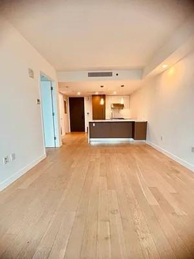 Unfurnished living room featuring light wood-type flooring and baseboards | Image 11