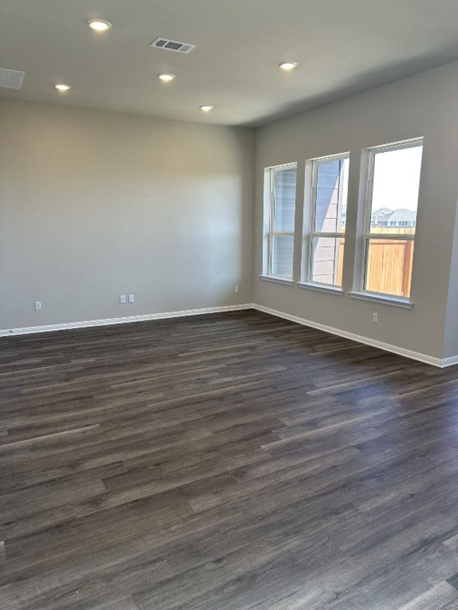 Unfurnished room with dark wood finished floors, baseboards, visible vents, and recessed lighting | Image 16
