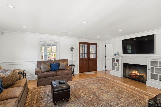 Living room with light hardwood / wood-style flooring and ornamental molding | Image 15