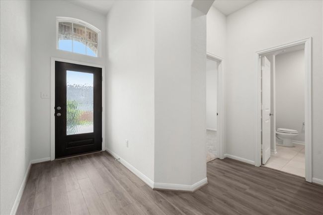 Entryway with LVP floors, healthy amount of natural light, baseboards, and a high ceiling | Image 27
