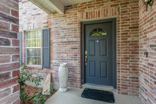 View of exterior entry featuring brick siding | Image 4