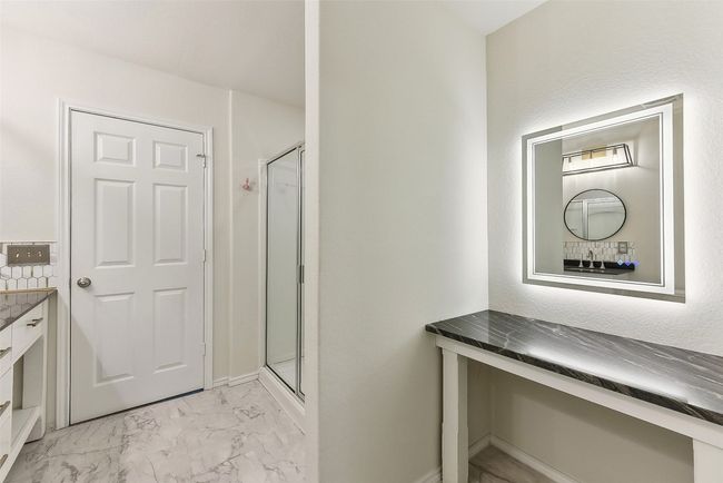 Bathroom featuring marble finish floor, a stall shower, and vanity | Image 21