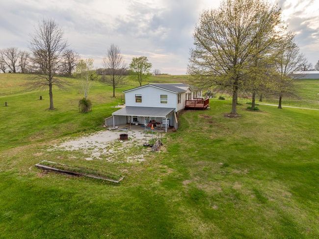 Rear view of house featuring a deck and a yard | Image 53