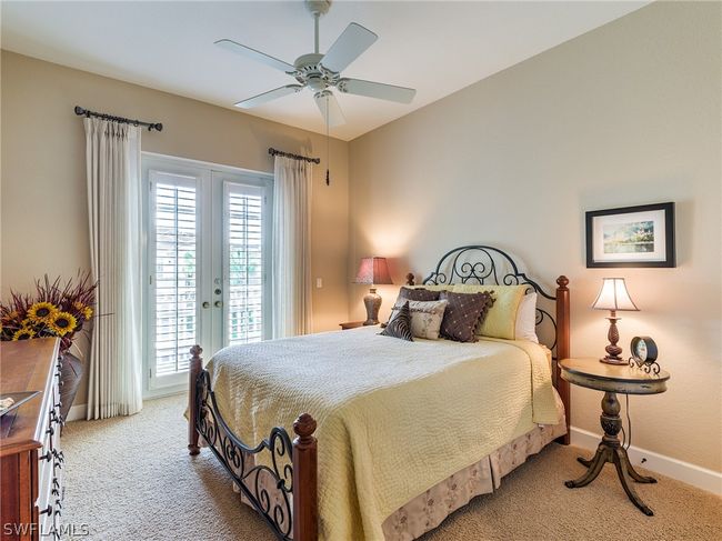 Bedroom featuring carpet flooring, access to exterior, multiple windows, and ceiling fan | Image 24