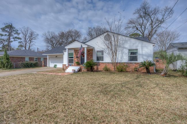 View of front of house with a garage, driveway, brick siding, and a front yard | Image 27