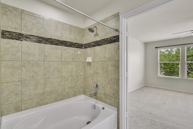 Full bath featuring baseboards and shower / bathtub combination | Image 26