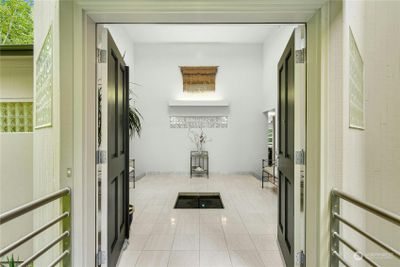 Welcome to this sunlit two-story foyer with a serene water fountain! | Image 3