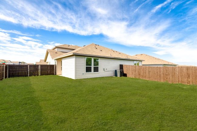 Back of house with central air condition unit, a fenced backyard, and a yard | Image 30