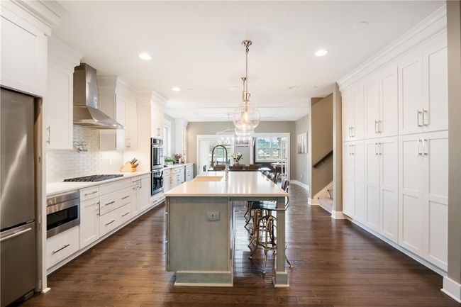 3 Large pantries with pull out shelves and outlets inside provide tons of storage and convenience. | Image 12