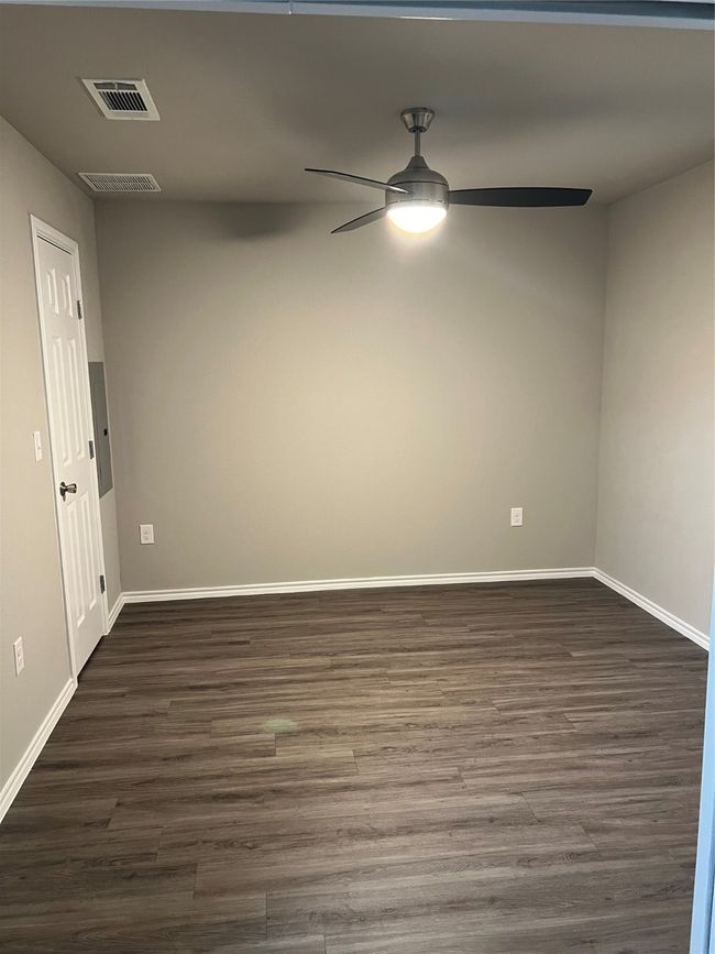 Spare room with ceiling fan, dark wood-style floors, and baseboards | Image 8