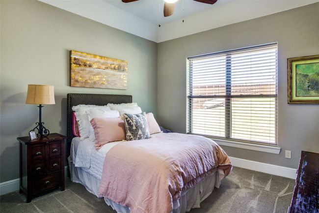 Bedroom featuring baseboards, a ceiling fan, multiple windows, and carpet | Image 21