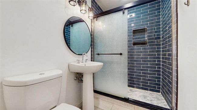 Bathroom with a tile shower, tile patterned flooring, and toilet | Image 24