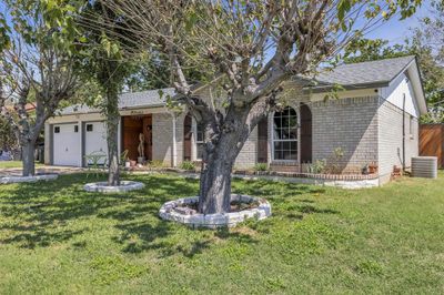 Single story home featuring a front yard, a garage, and central AC | Image 2