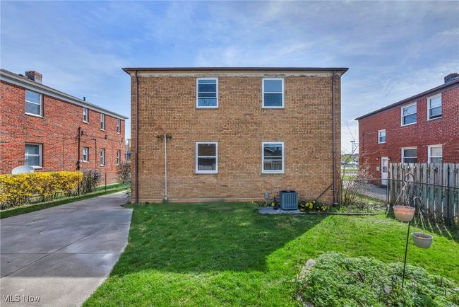 Back of property with central AC, a yard, and brick siding | Image 4