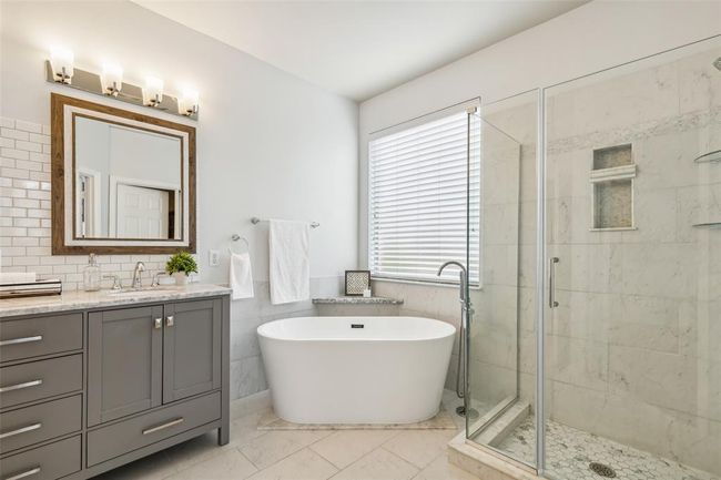 Bathroom featuring oversized vanity, tile walls, tile floors, and plenty of natural light | Image 16